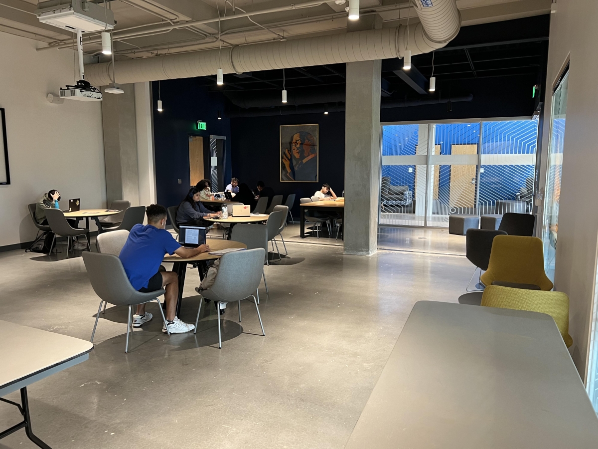 Room with people sitting at round tables